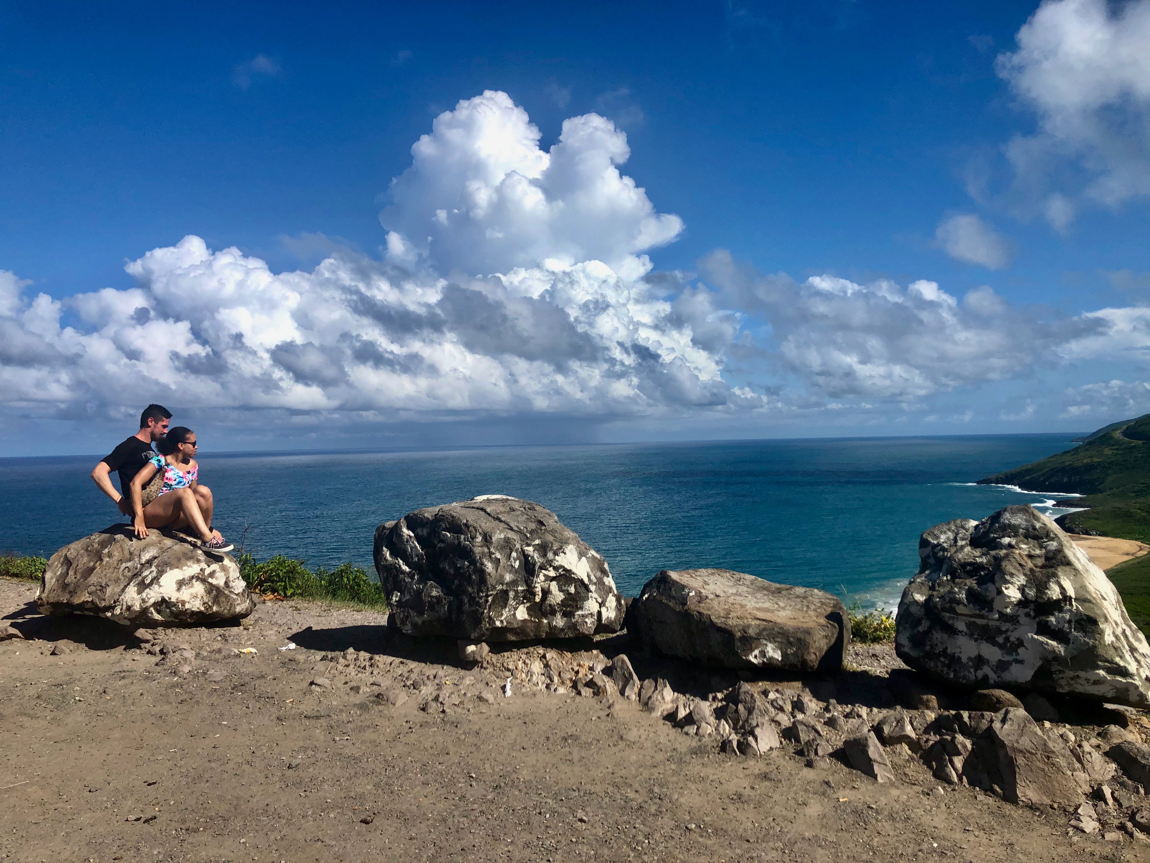 Couple at a scenic overlook with coastal views
